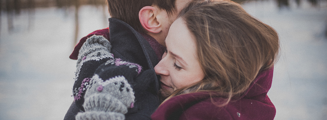 Couple hugging in the snow