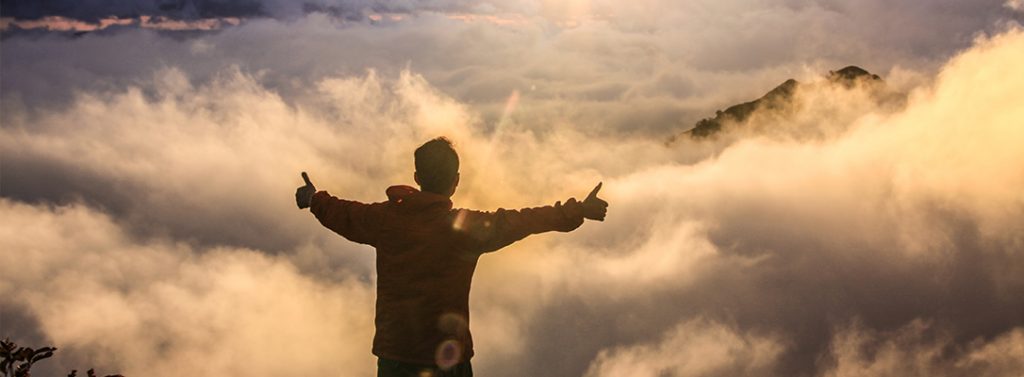 Man at the top of a mountain