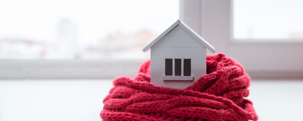 Toy wooden house wrapped in a blanket