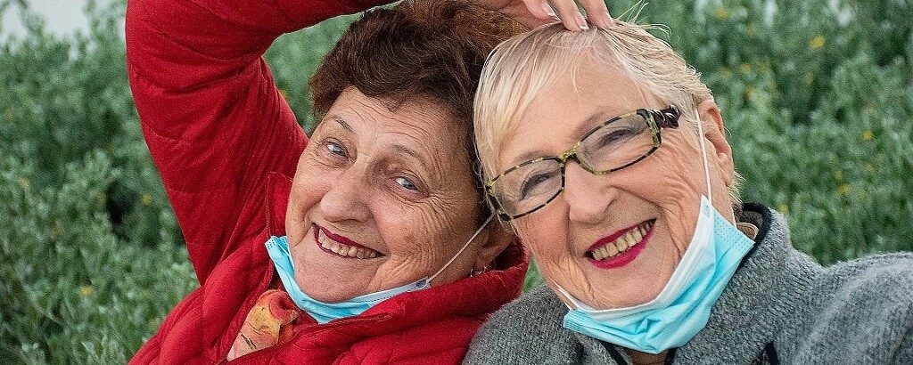 two elderly women fighting loneliness together