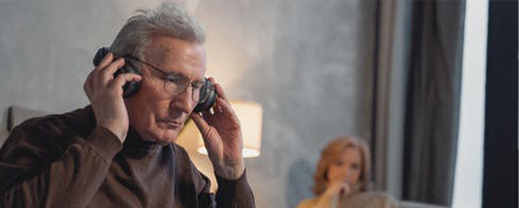 elderly man listening to the best audible books at home