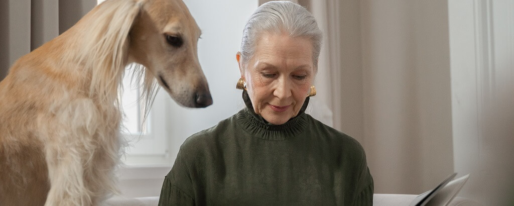 elderly woman spending national pet day with her dog