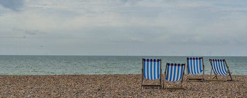 deckchairs on a beach at one of the best holiday destinations for over-60s